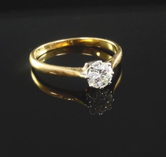 An 18ct gold and platinum solitaire diamond ring, size O.